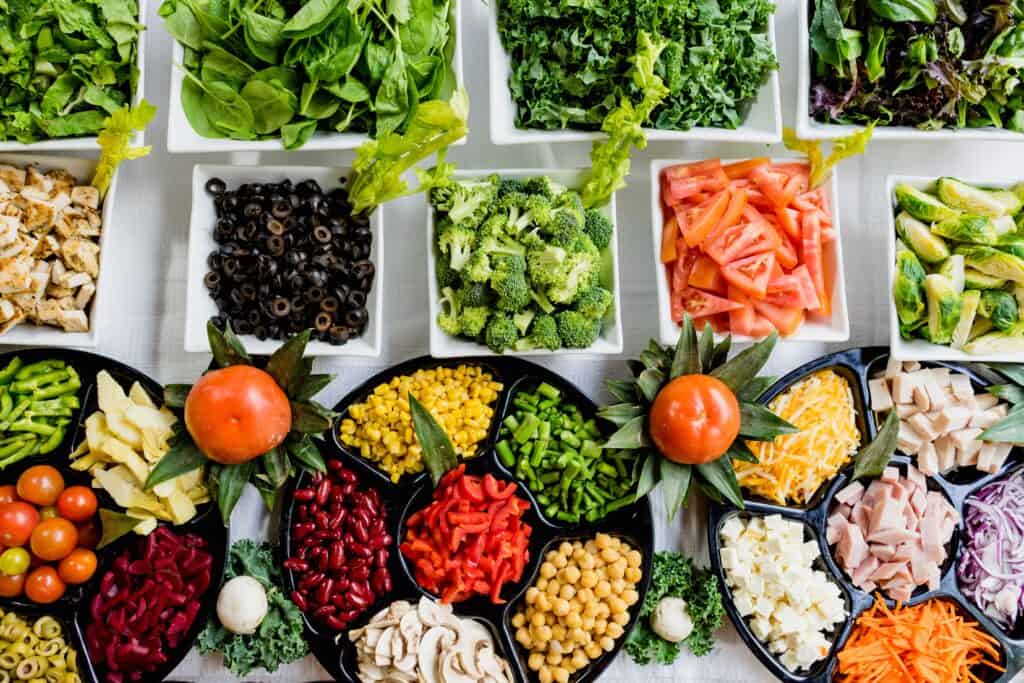 Fresh vegetables in bowls on a table to be used in a Compact Countertop Freeze Dryer