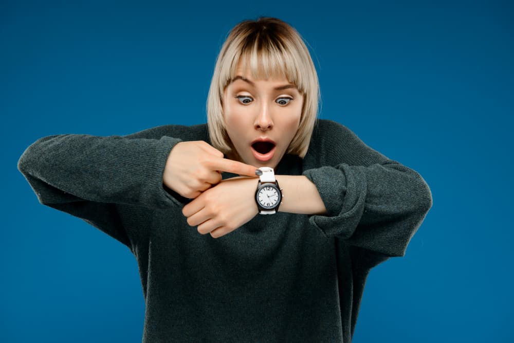 Woman looking at watch to see how long does freeze drying food take.